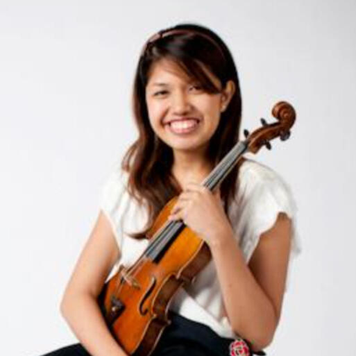 Tanned skinned violin teacher in a white top, holding a violin